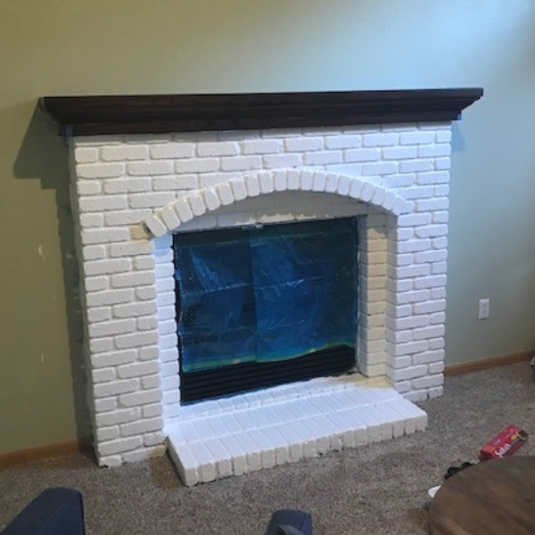 Brick fireplace painted white