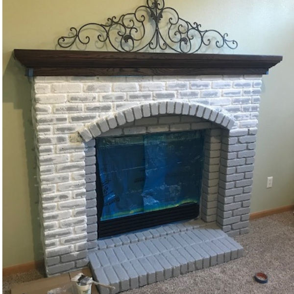 Painted brick fireplace in process